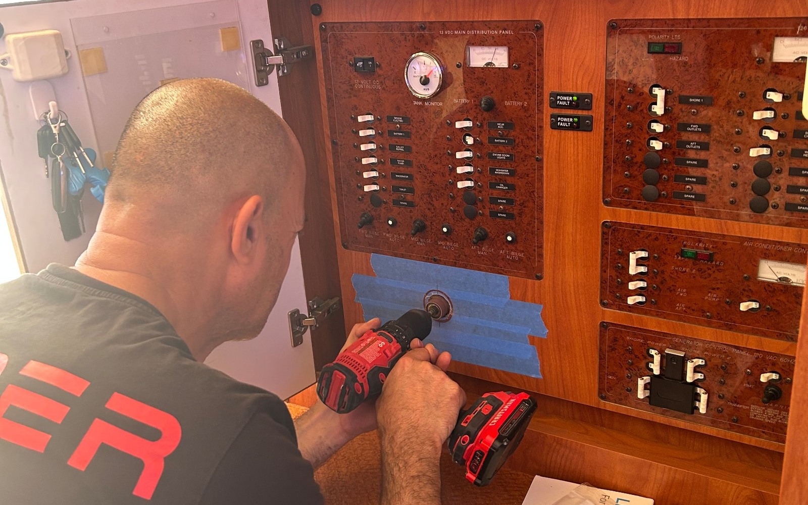 Technician working on an onboard electrical distribution panel
