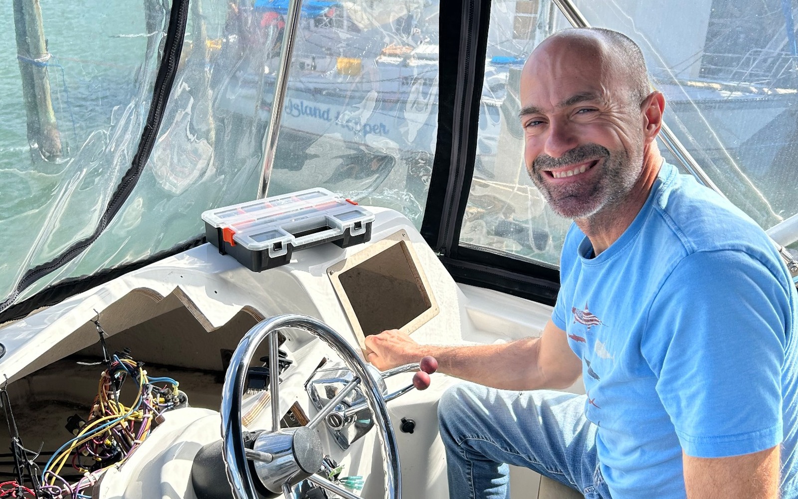 Freebird Marine technician at the helm during a marine electronics refit