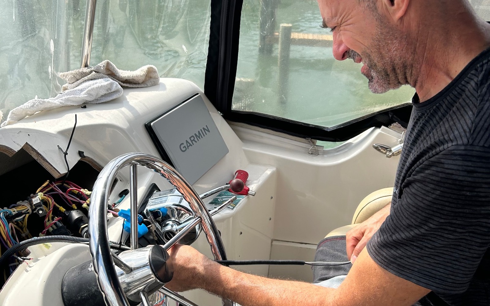 Technician troubleshooting marine helm electronics